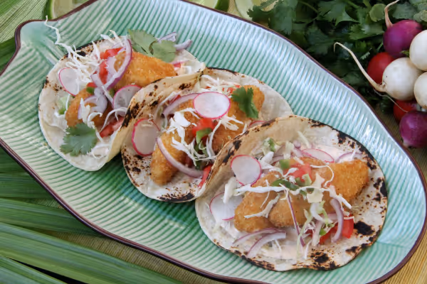 a plate of food with a slice of cake on a table
