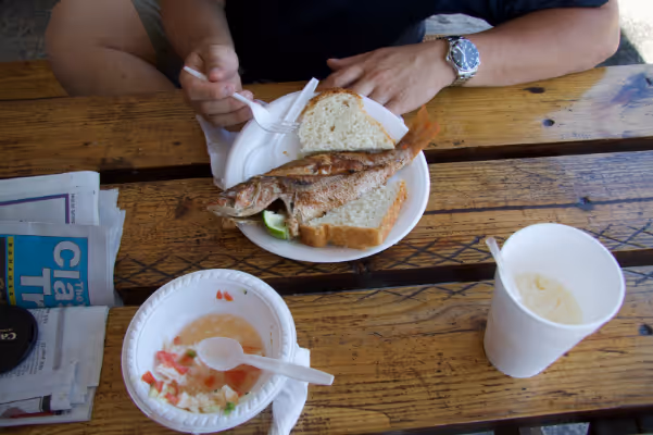 a person sitting at a table eating food