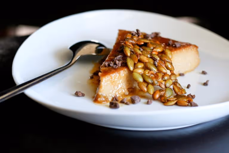 a white plate topped with food next to a fork