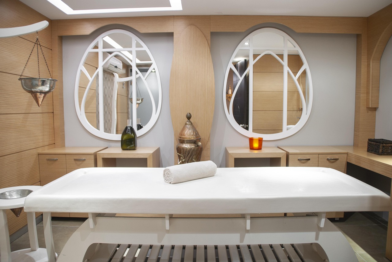 A quiet massage room with folded white towels, set up before a couples session