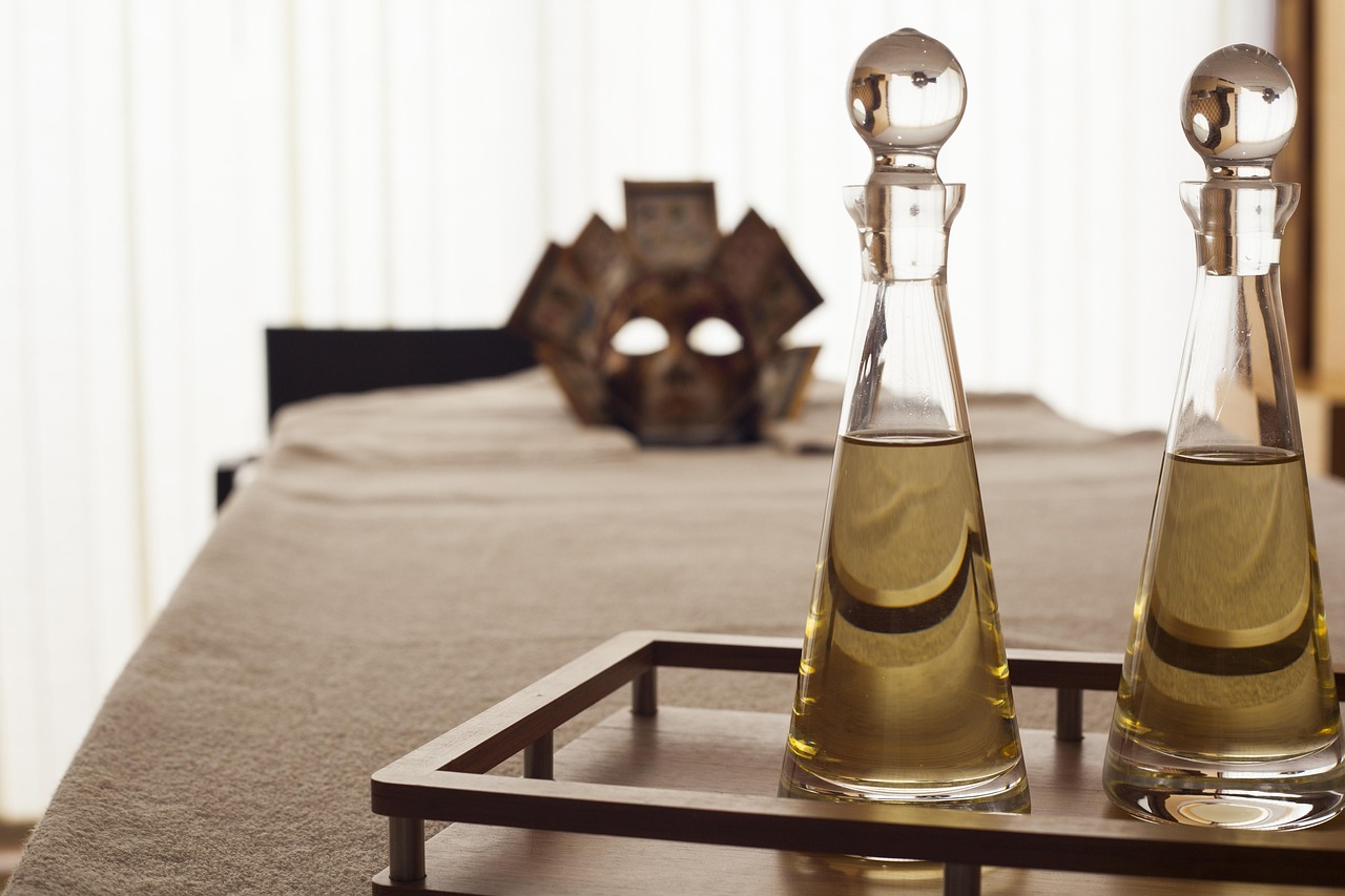Massage oil and towels laid out in a calm treatment room