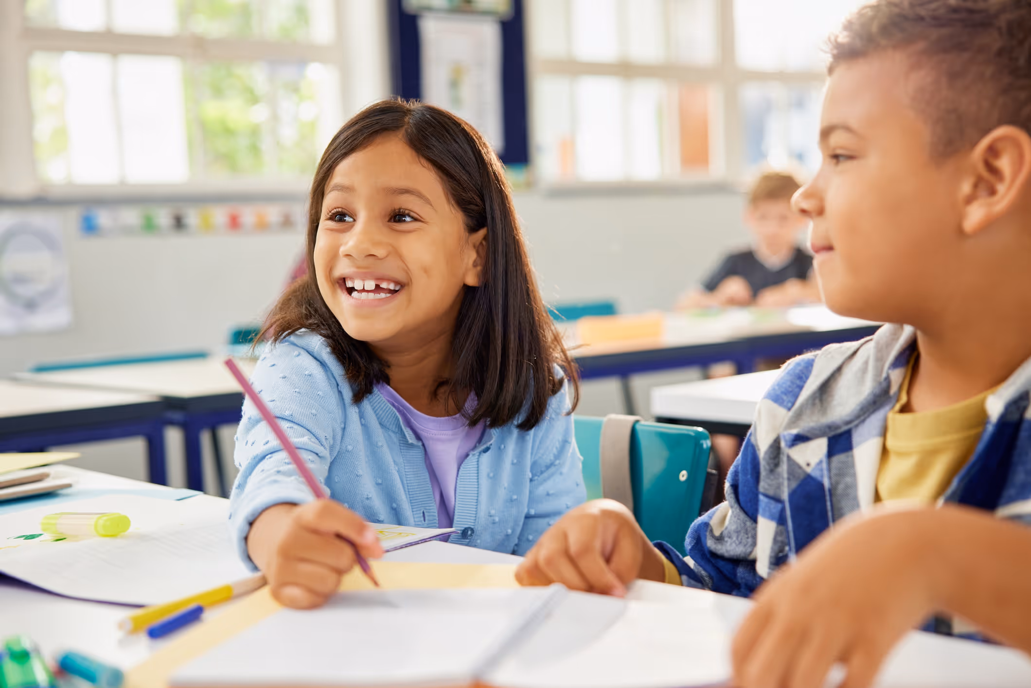 Girl smiling, participating in class during observation for a psychoeducational evaluation