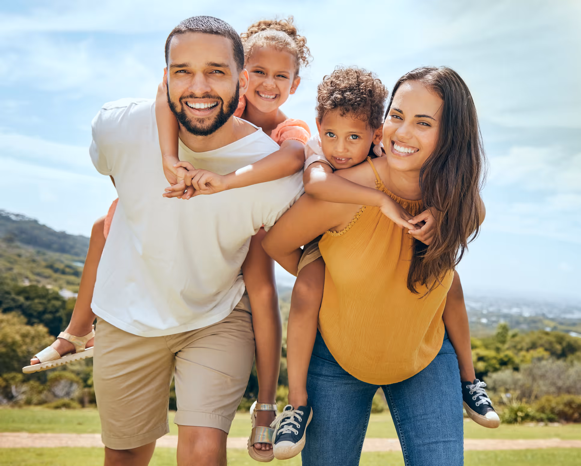 Happy family of four (parent and two children) smiling after a successful counseling session