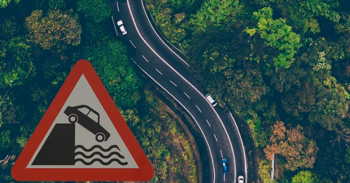 sign showing a car dirving off a cliff