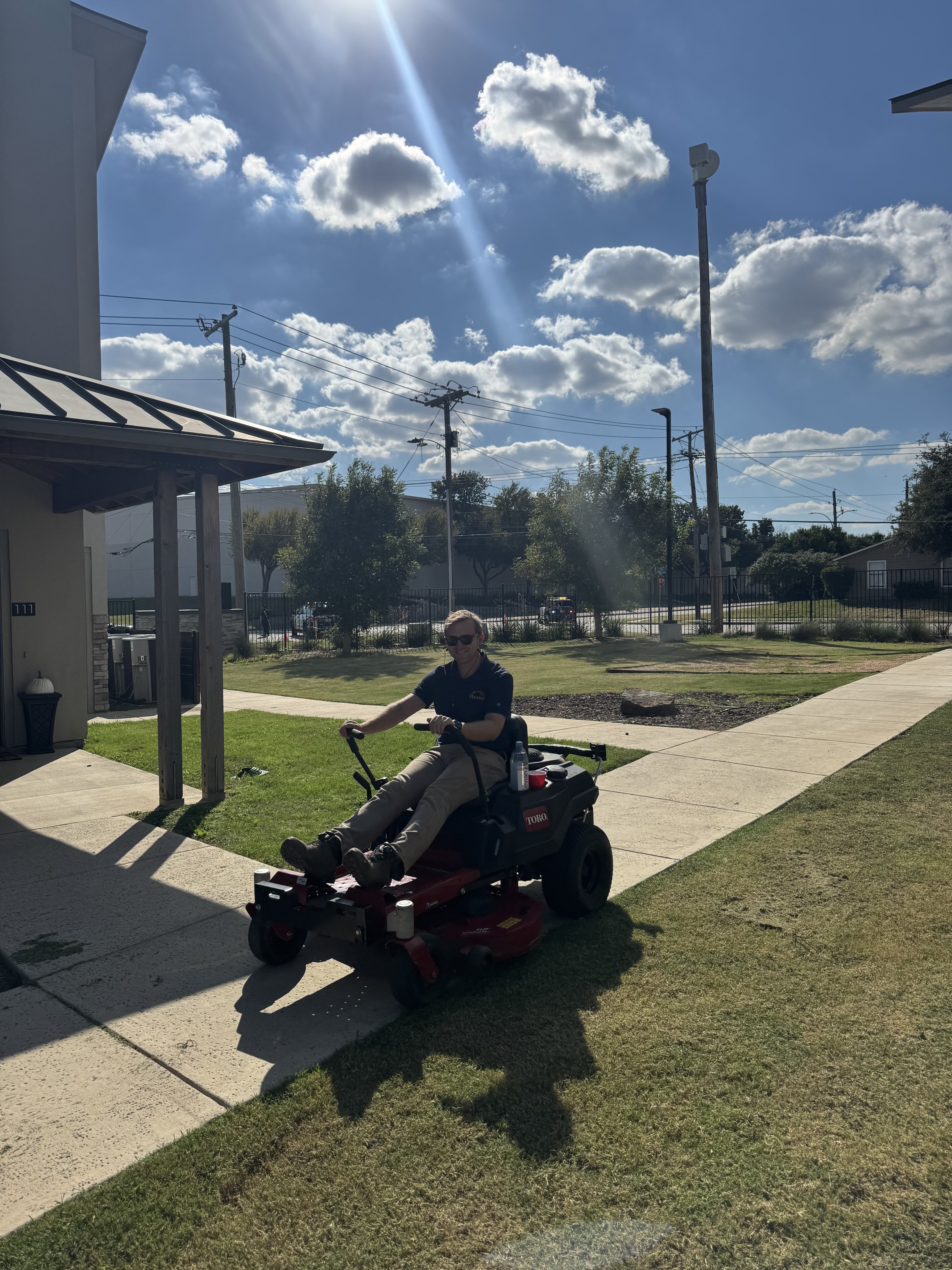 Worker Driving Lawnmower