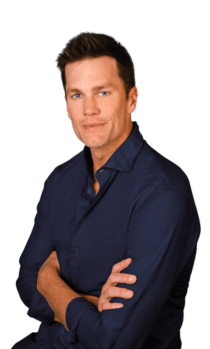 Man with blue eyes and brown hair wearing a navy blue shirt with arms crossed, looking at camera.