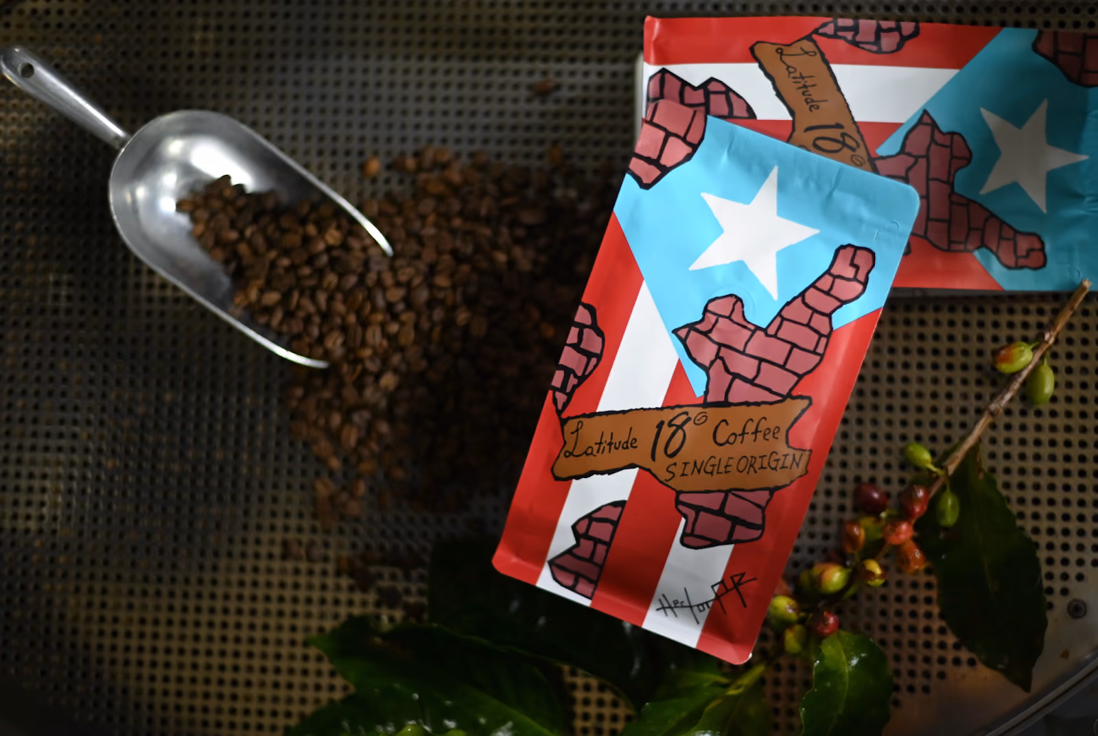 Coffee beans spilled from scoop next to two bags of Latitude 18° single origin coffee with Puerto Rico design.