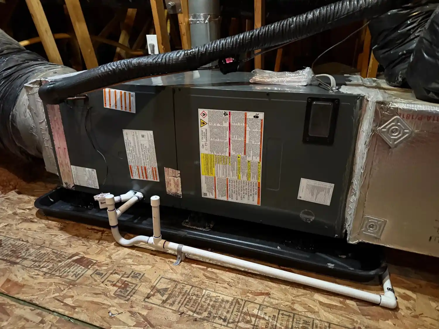 HVAC air handler in attic on drain pan.