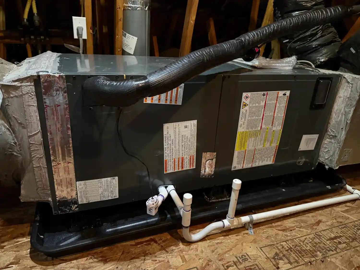 HVAC air handler in attic on drain pan.