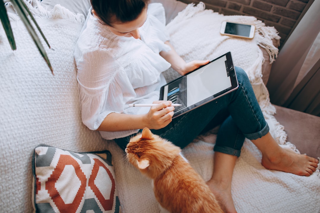 homeowner calculating costs on a tablet inside a comfortable living room homeowner calculating costs on a tablet inside a comfortable living room