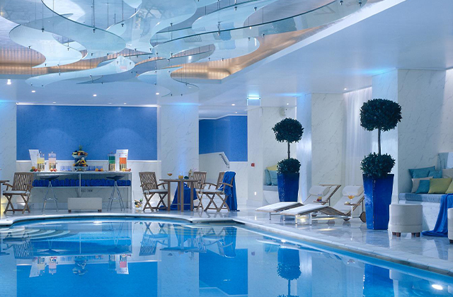 G Spa's indoor pool featuring an art installation on the ceiling.