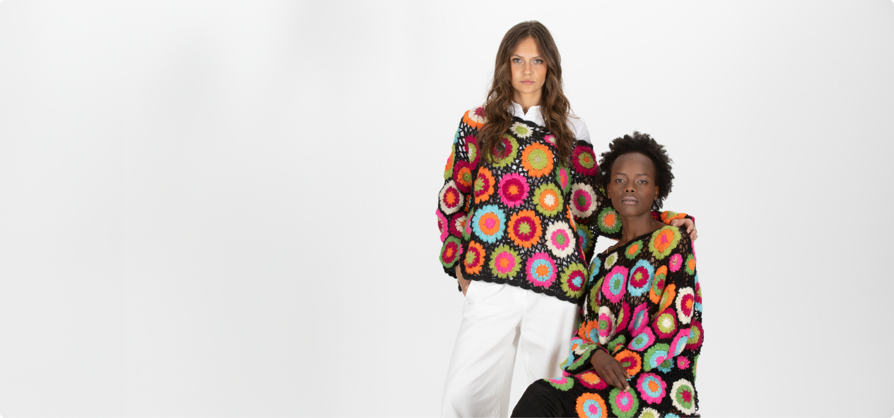 Zwei Modelle in farbenfroher floraler Shivadiva-Strickmode auf weißem Hintergrund