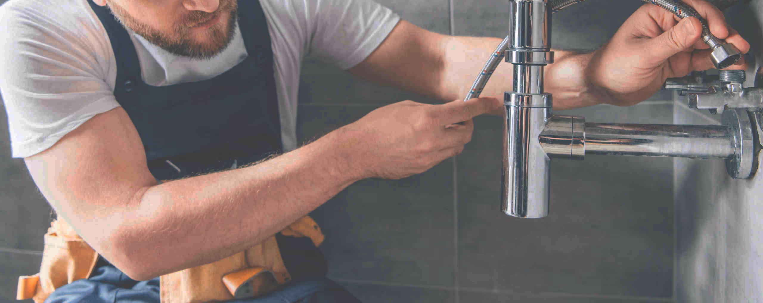 Plumber working on faucet