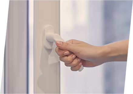 A hand holds a white door handle, highlighting the message to keep doors and windows closed for safety.