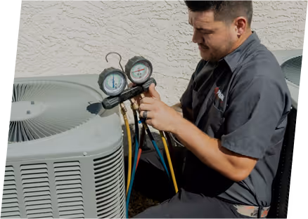 A man examines the air conditioning unit, ensuring the condenser coil is clean for efficient cooling.