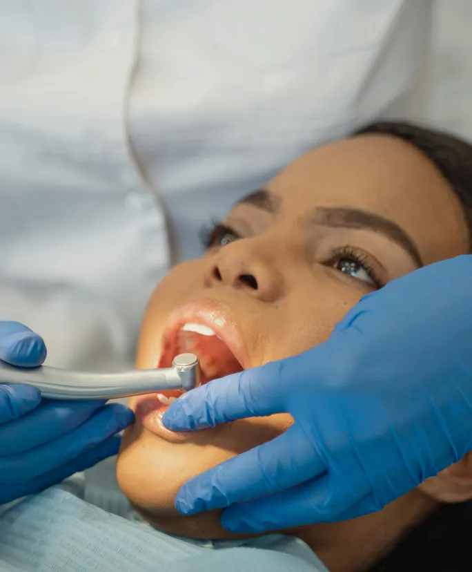 Dental patient receiving treatment with dentist using dental tool