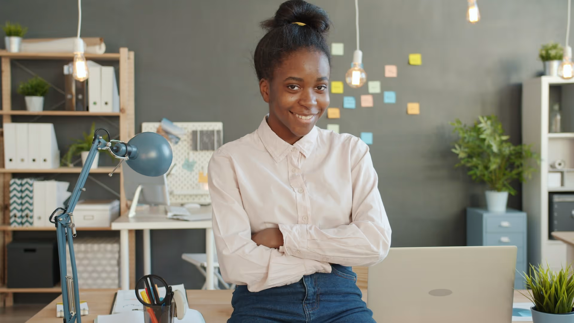 Smiling professional in white shirt at modern office workspace