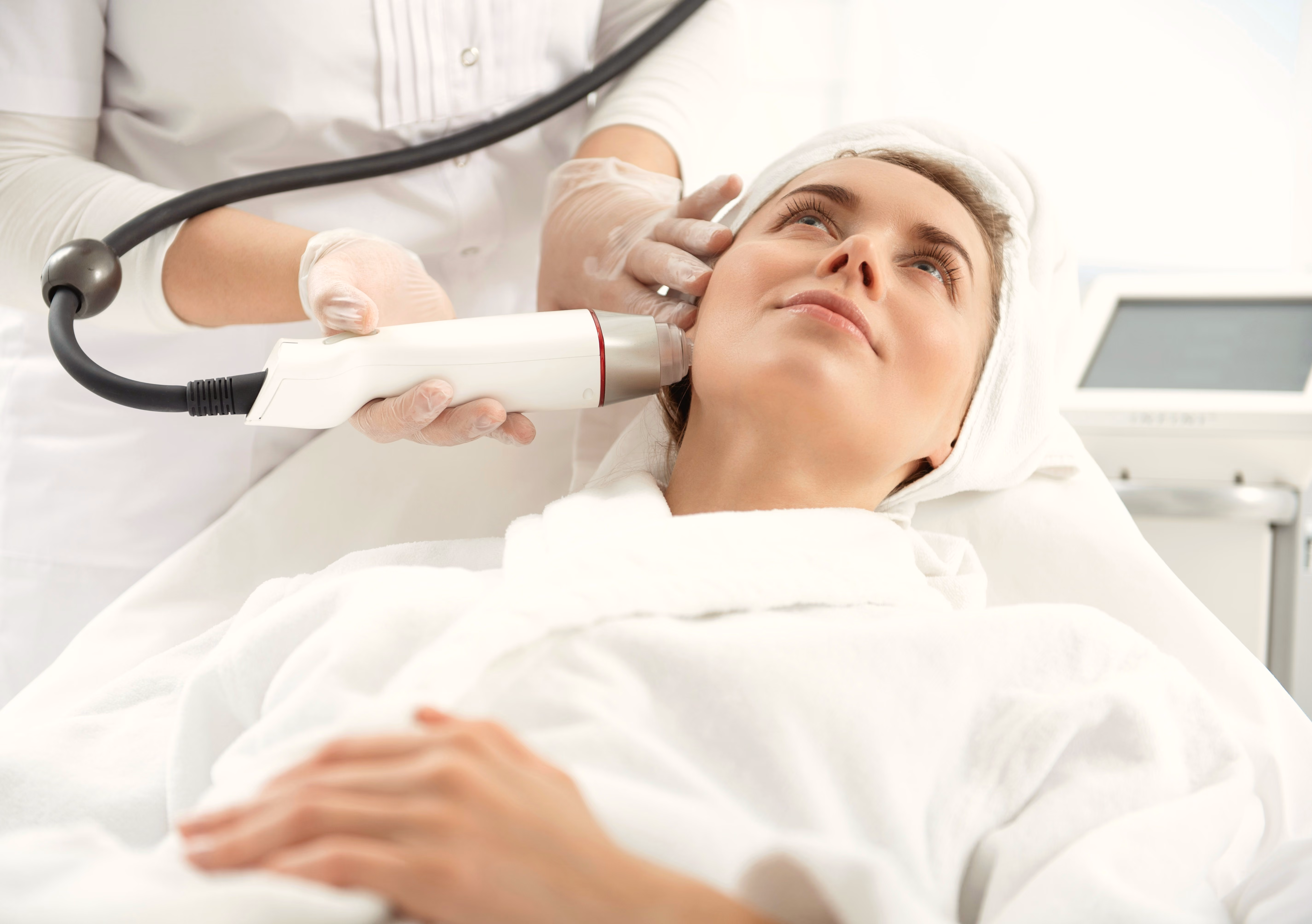 Woman receiving a personalized facial treatment at a med spa.