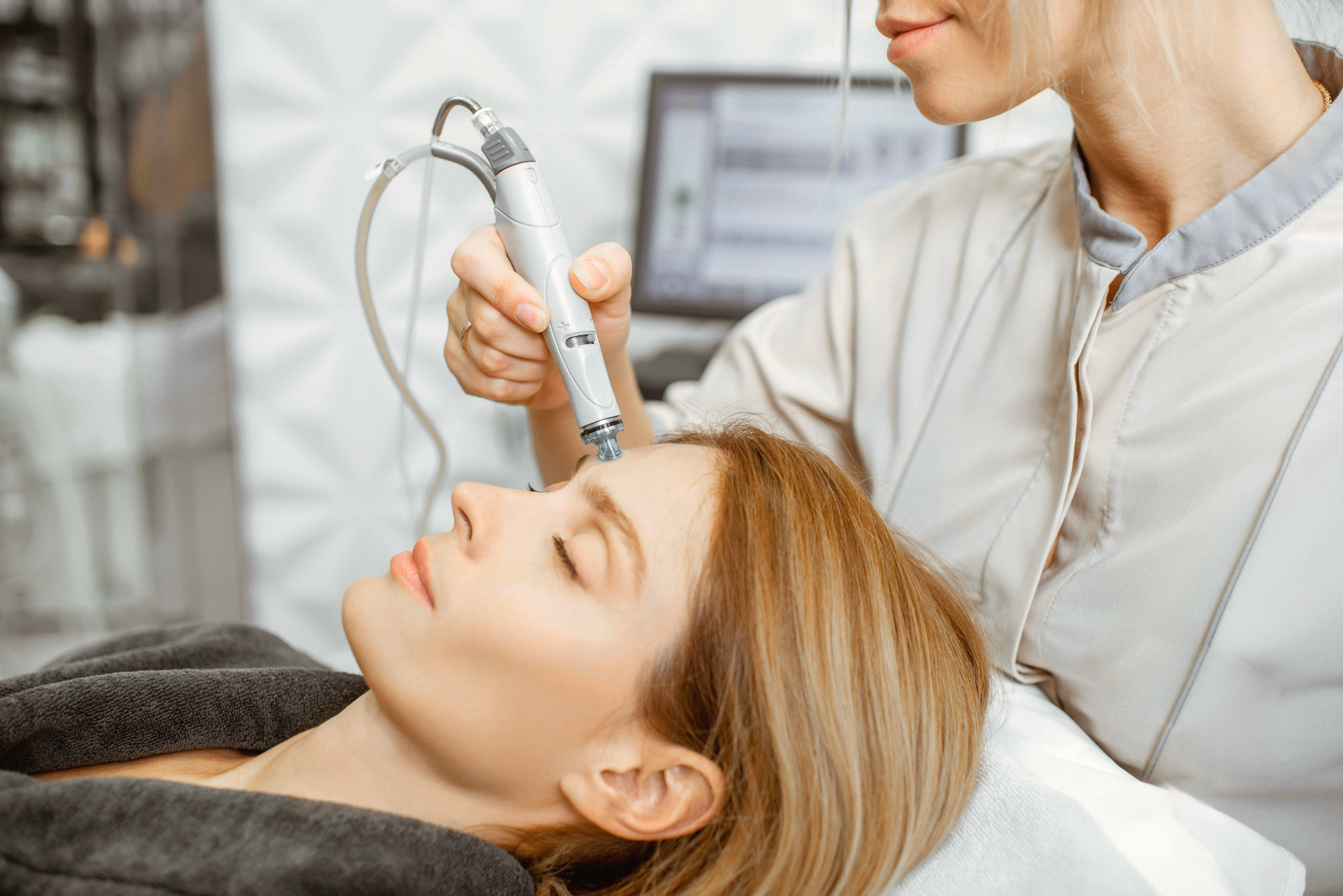 Woman receiving an advanced facial skin treatment.