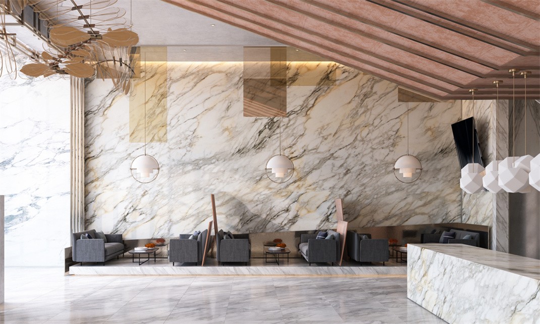 A project featuring a tall calacatta gold marble accent wall in an elegant and luxurious lobby space