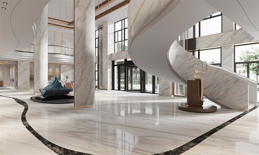 An elegant interior of a lobby showcasing the staircase and interior features cladded in calacatta gold marble