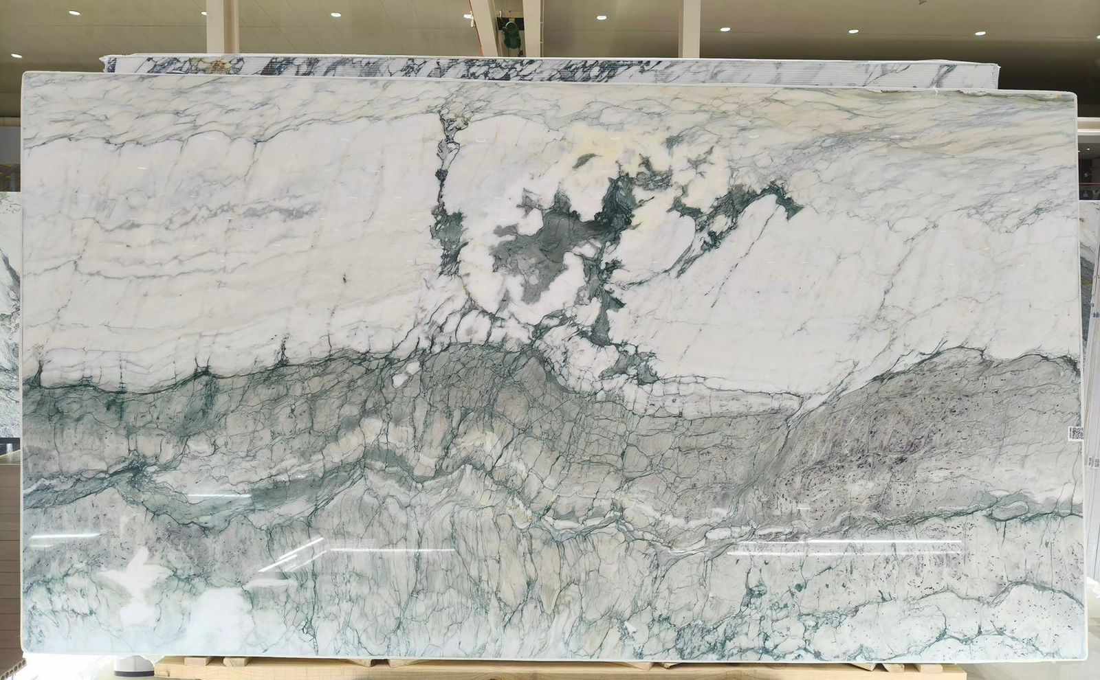 A full slab photo of dragon jade marble showacasing its unique dragon spine veining