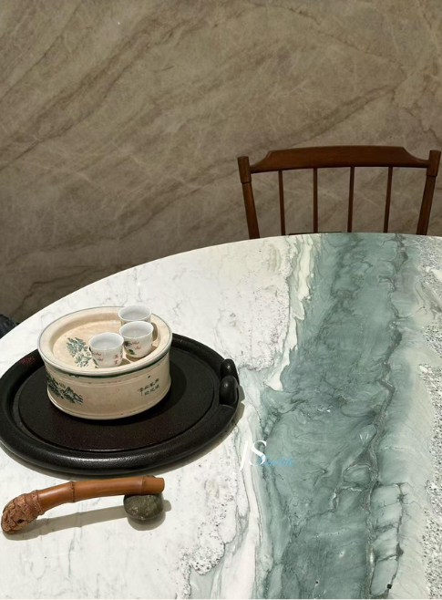An elegant and artistic round dining table top made from dragon jade marble perfect for the modern and traditional interiors