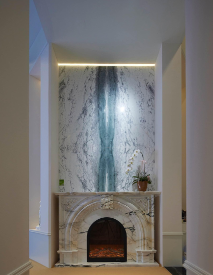 A well curated focal point featuring a majestic fireplace cladding made from dragon jade marble