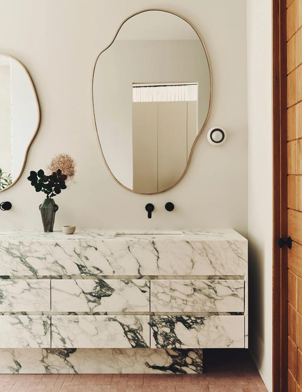 Calacatta monet integrated sink in modern organic bathroom