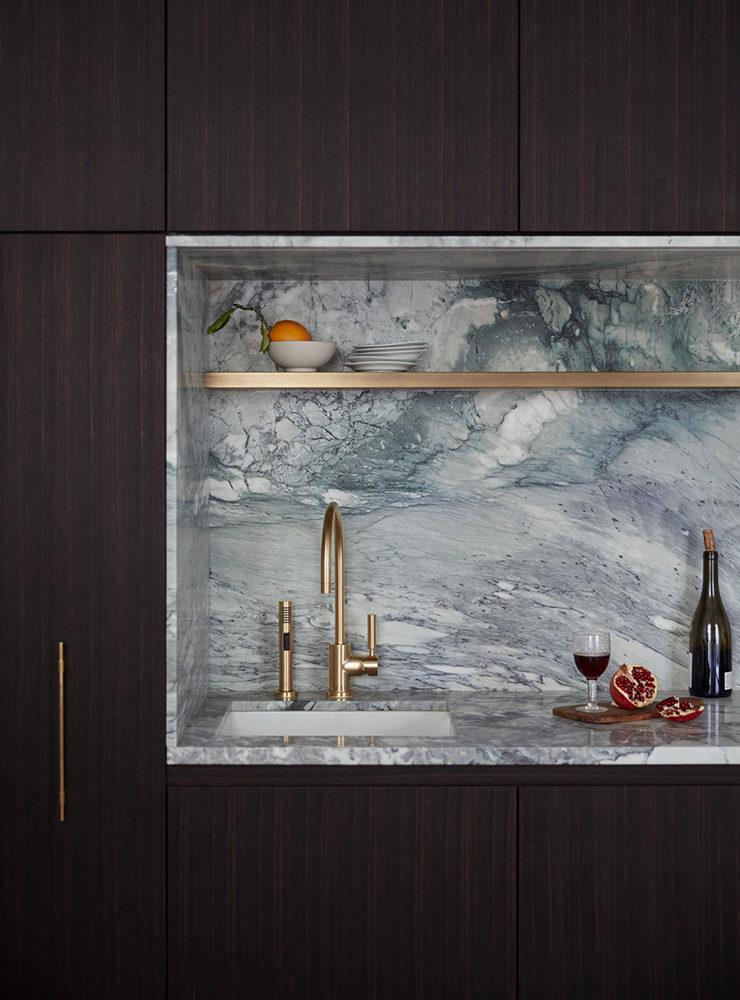An artisanal kitchen interior featuring the artsy picasso marble as kitchen backsplash and countertop