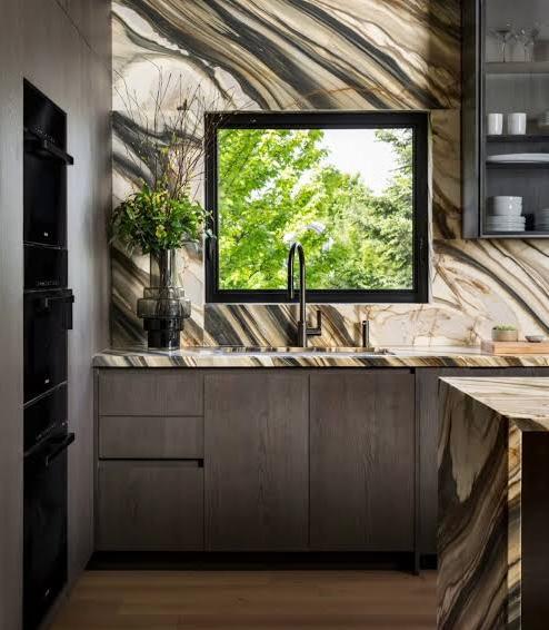 A full kitchen design that is both captivating and striking using calacatta oyster marble