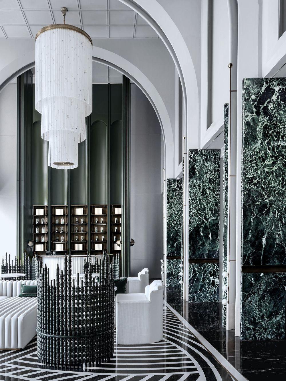 Prada green marble cladded columns in a high-end lobby interior project