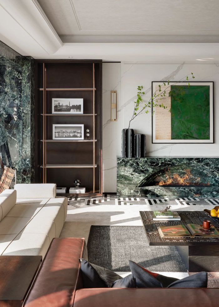 An understated luxurious interior with prada green marble as its accents used in media cabinet and columns creating character in the space