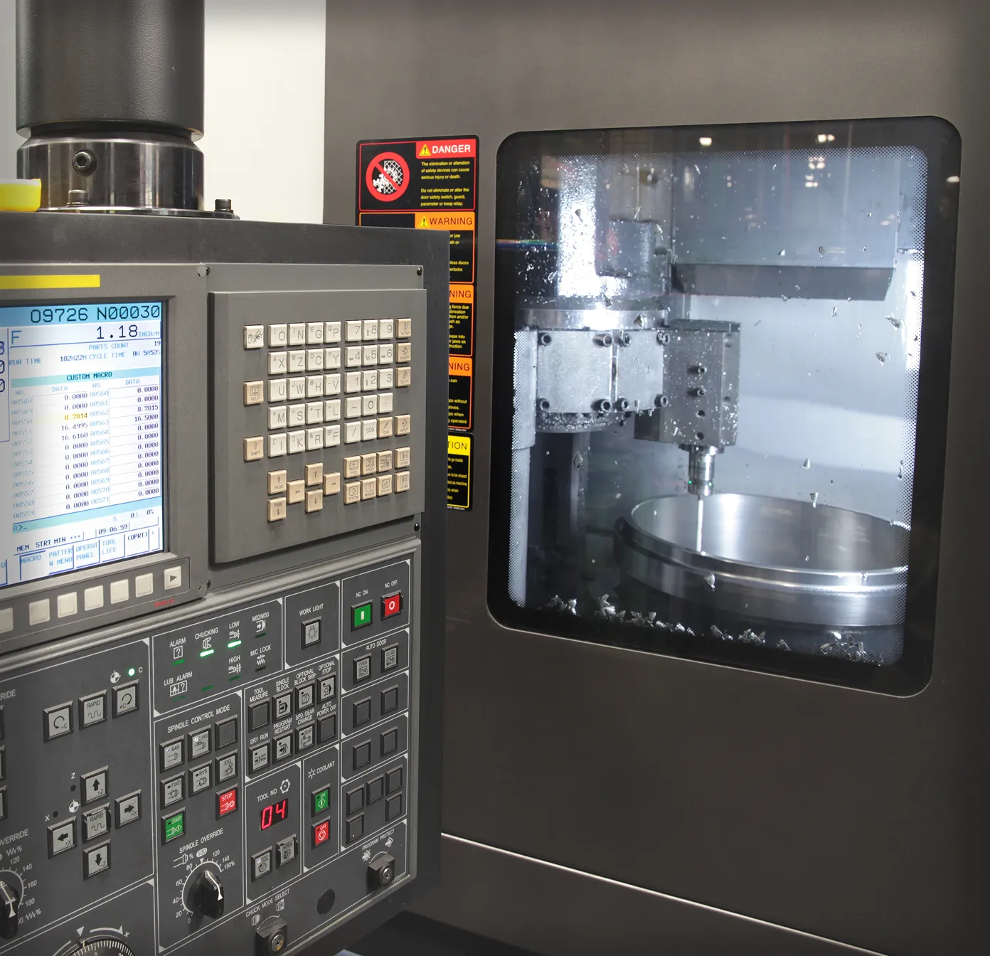 Mechanic wearing black gloves installing a brake pad on a car's brake disc.