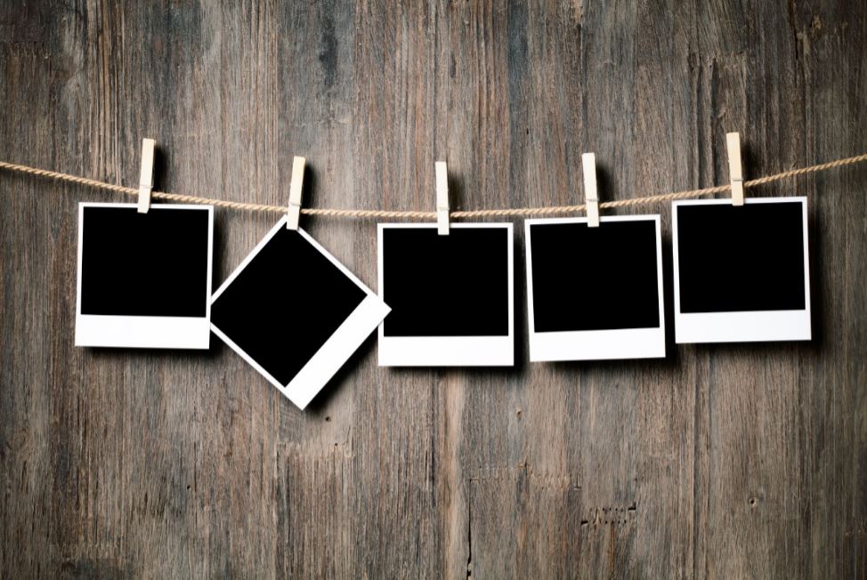 A row of polaroid pictures with one crooked picture.