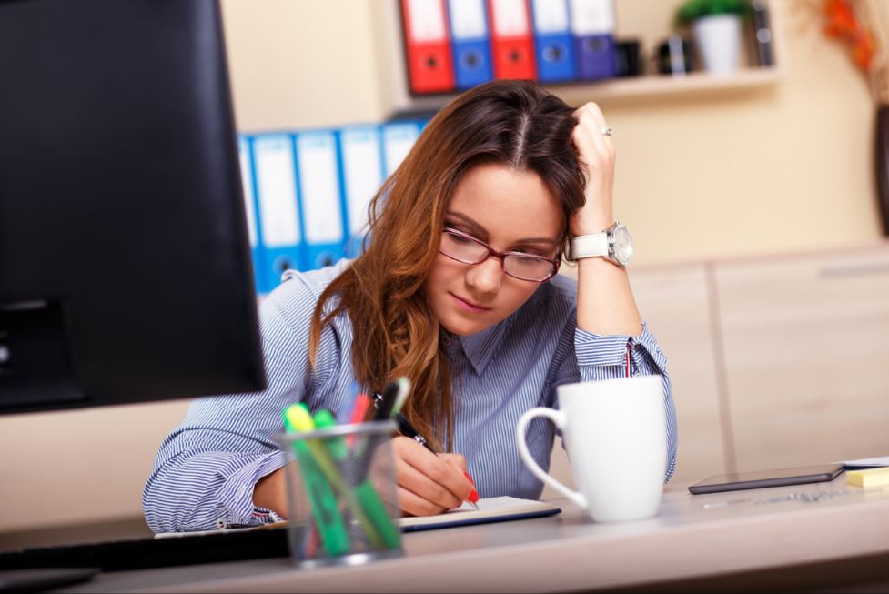 Business woman focusing at her desk.