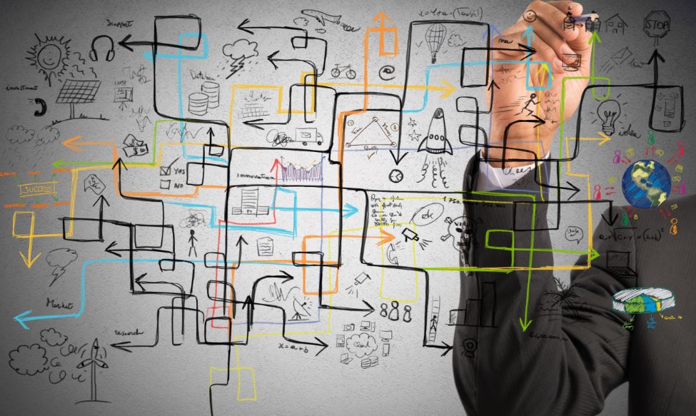 Businessman drawing on glass.