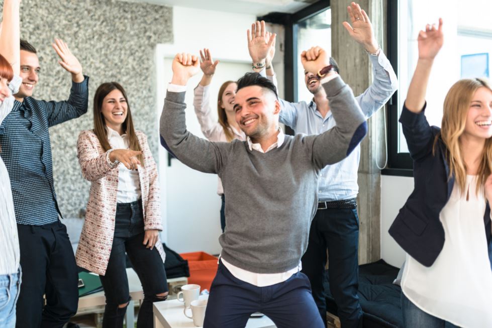 Employees dancing together for team building