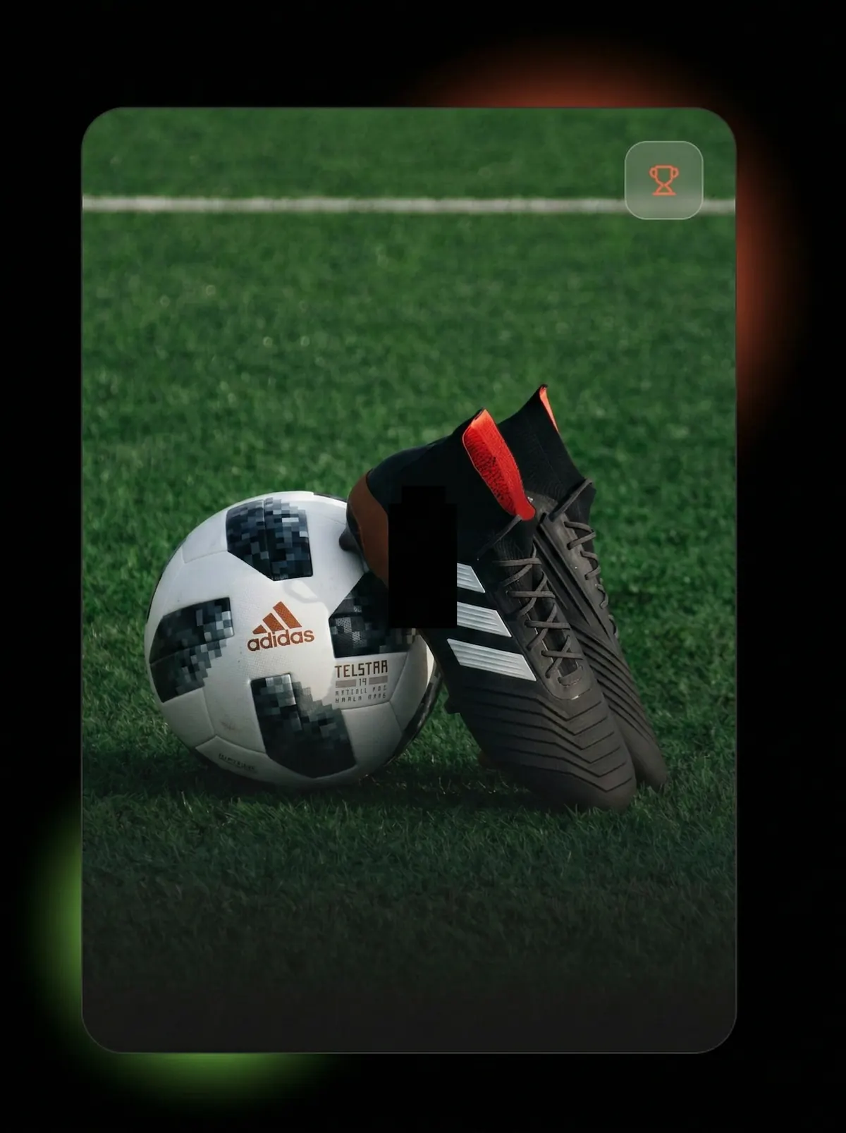 Black Adidas soccer cleats with white stripes resting against a white and black Adidas Telstar soccer ball on green grass.