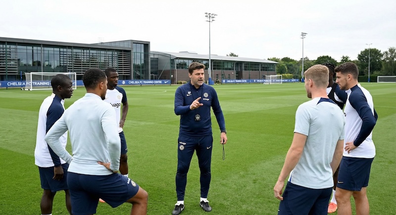 Coach talking to players at an academy training ground
