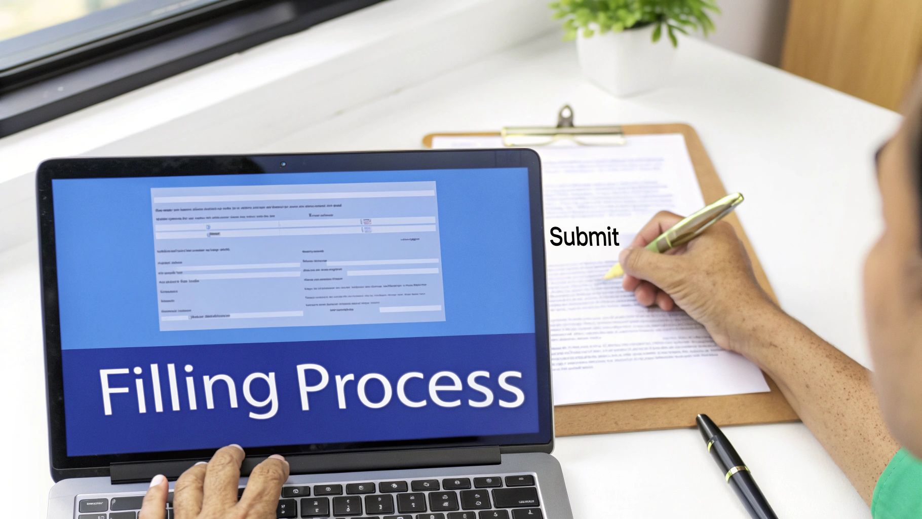 A person uses a laptop for an online form while also writing on a physical document, indicating a dual filling process.