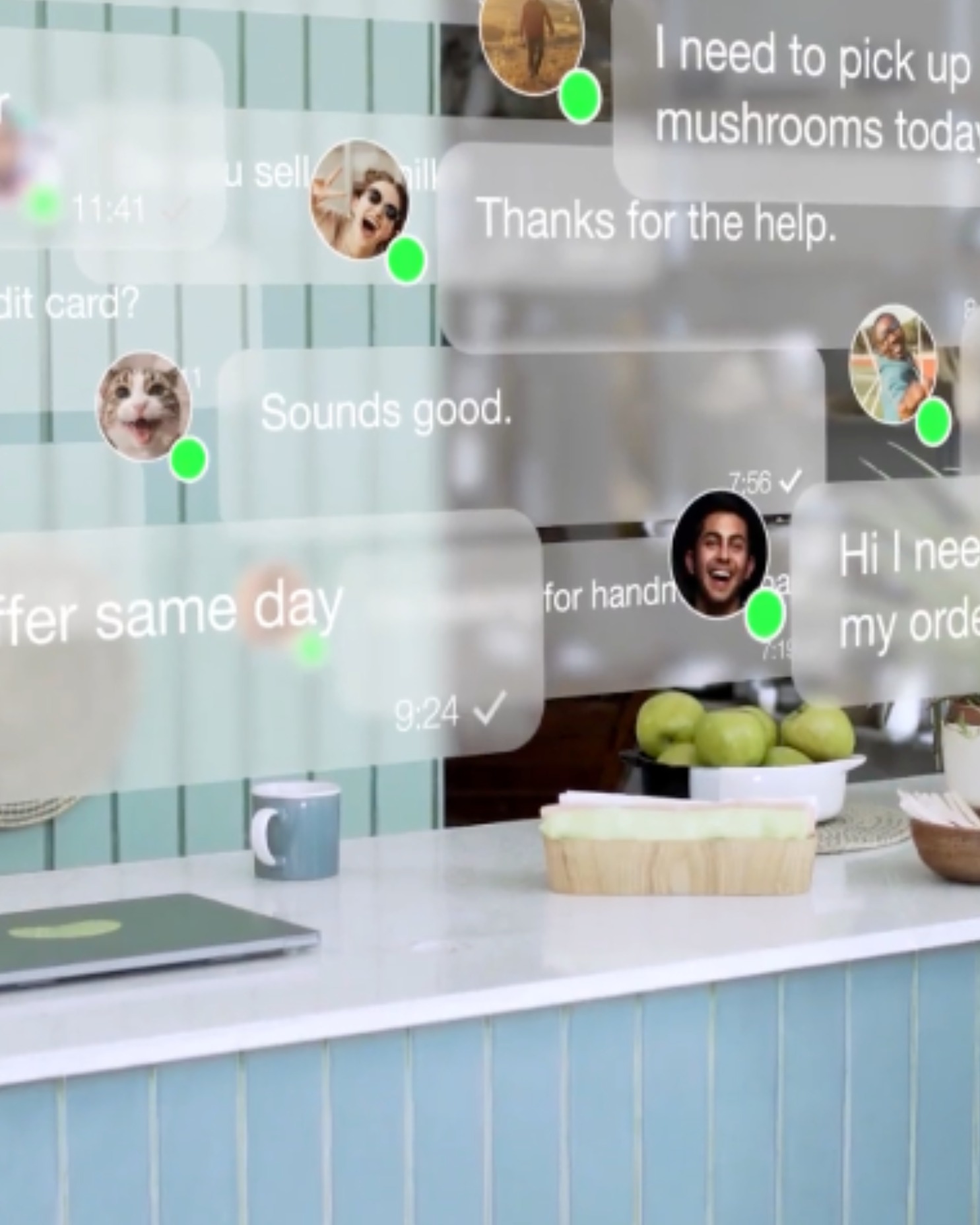 Kitchen counter with a laptop, coffee mug, bowl of green apples, and chatting app message bubbles with profile pictures floating above.