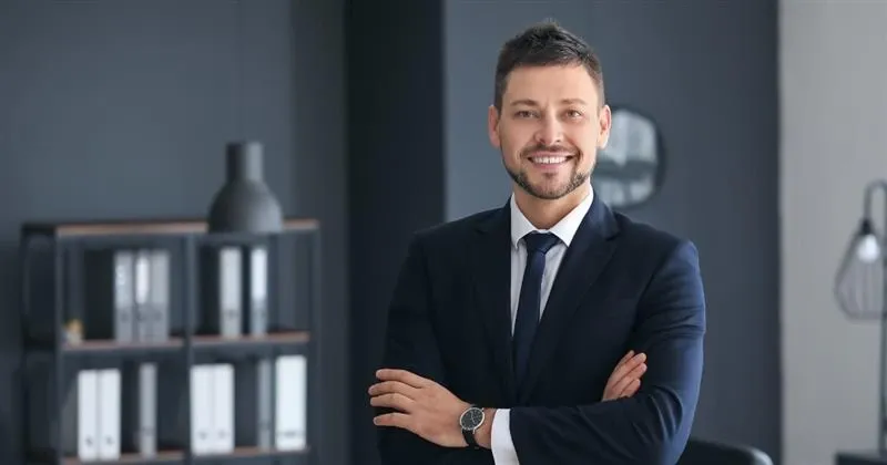 Grayscale image of a robotic arm in a clean, modern environment.