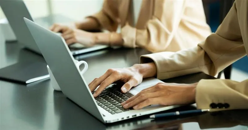 Grayscale image of a robotic arm in a clean, modern environment.