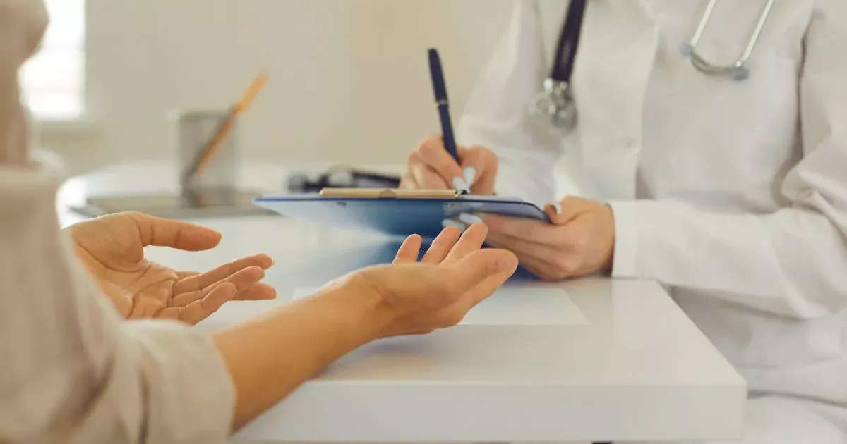 Grayscale image of a robotic arm in a clean, modern environment.