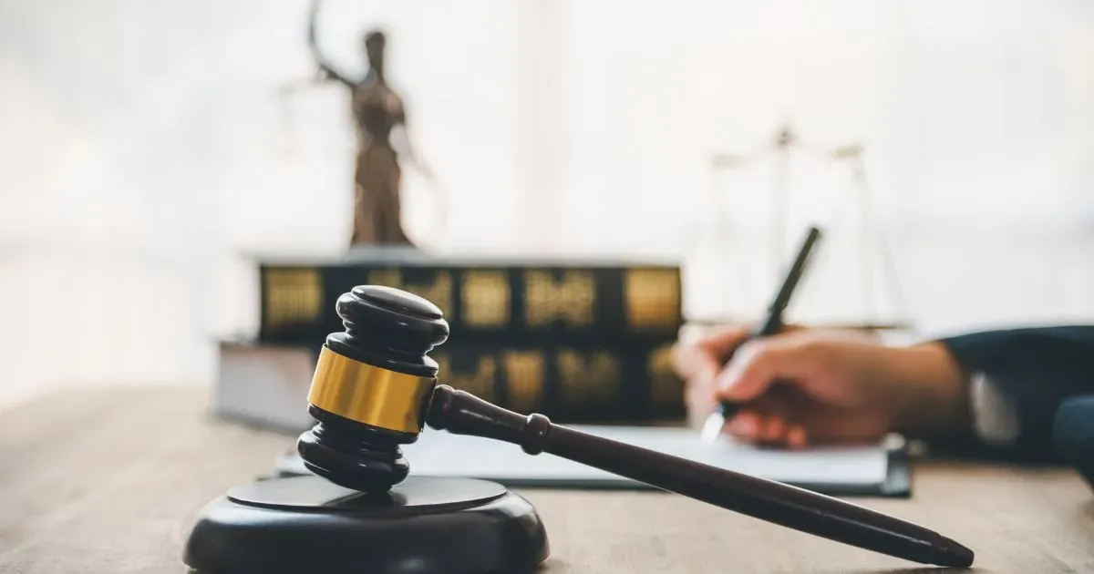 Grayscale image of a robotic arm in a clean, modern environment.