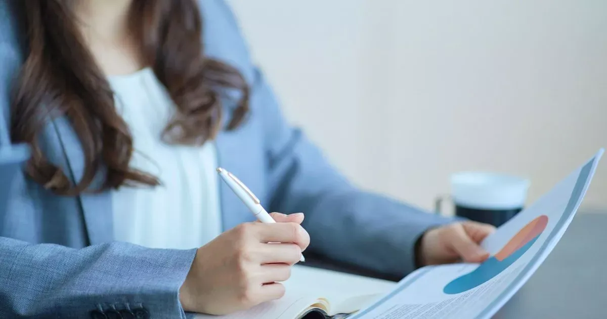 Grayscale image of a robotic arm in a clean, modern environment.