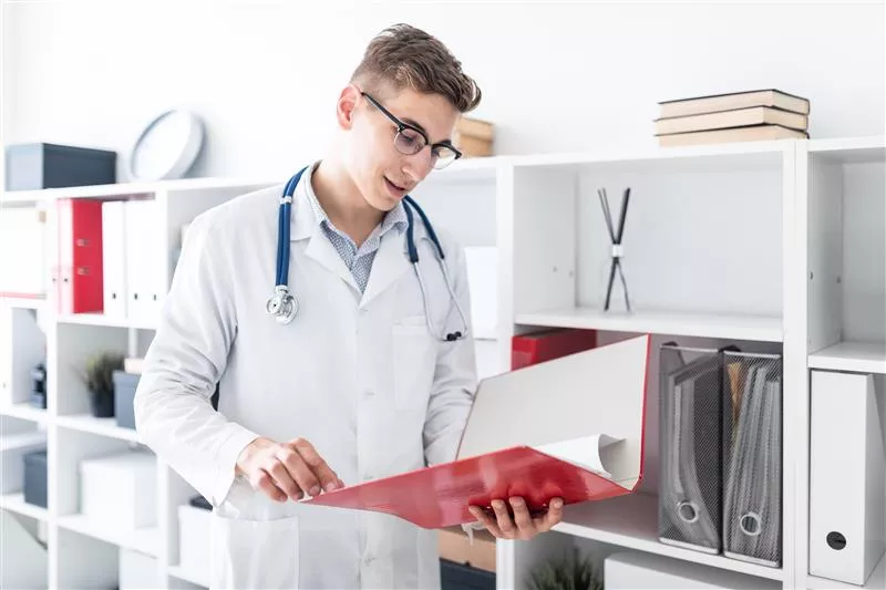 Grayscale image of a robotic arm in a clean, modern environment.