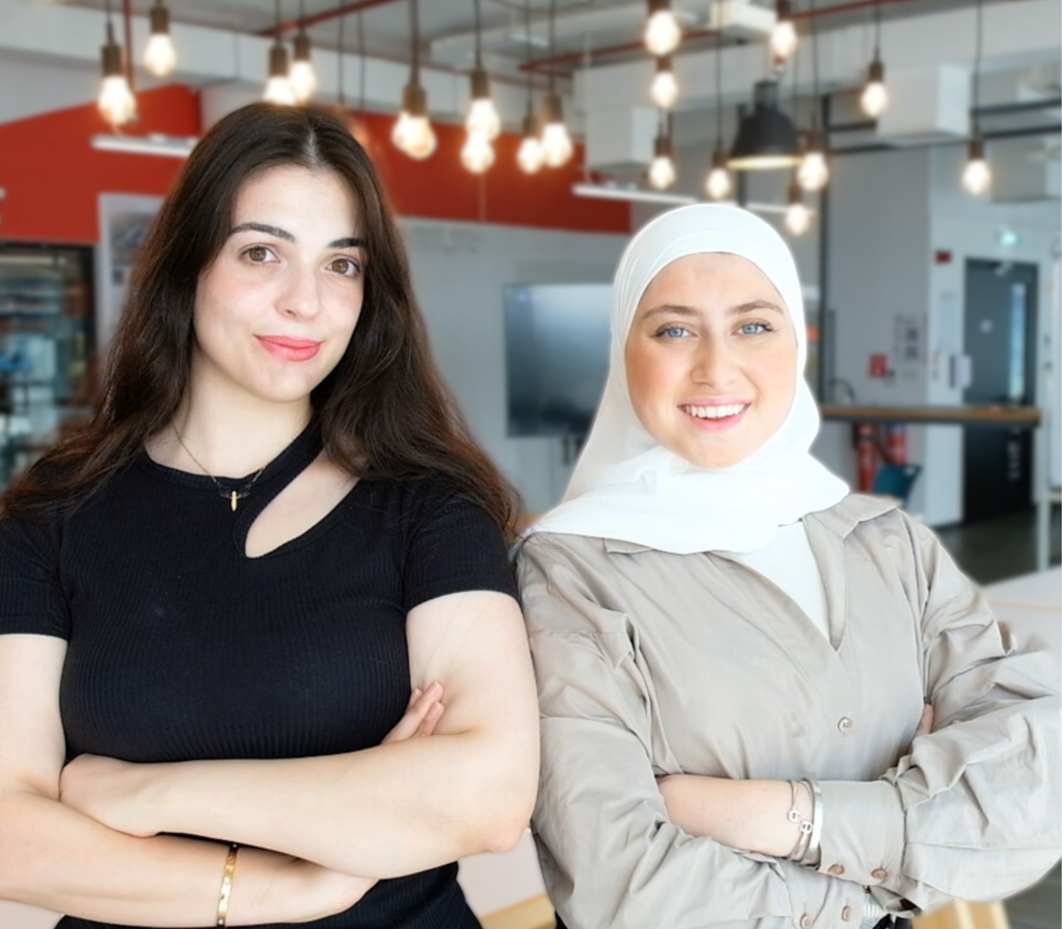 Two female students, one in black and the other in gray, both wearing hijabs