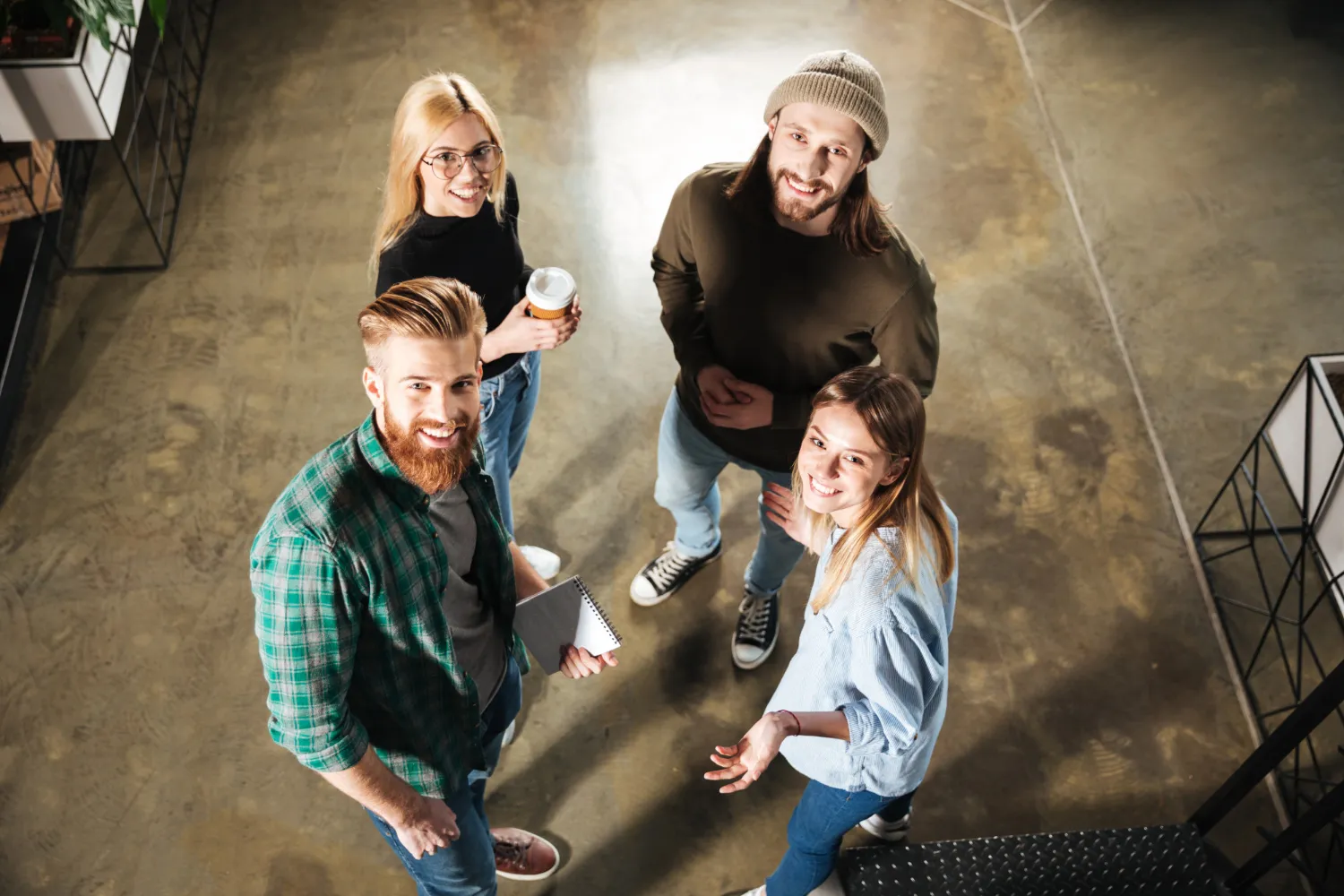 Marketing or creative team standing together during a meeting.